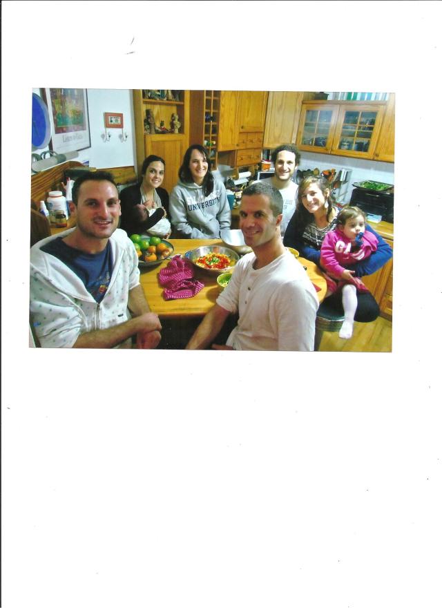 At the kitchen table, reenacted a few years later. Back row, Libi, with Eyal, her son who's now two, Amalia, Ari, Libby with Abigail, Izzy and Shlomie.